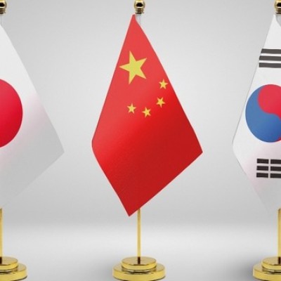 The trilateral summit measures South Korea's diplomatic shift.