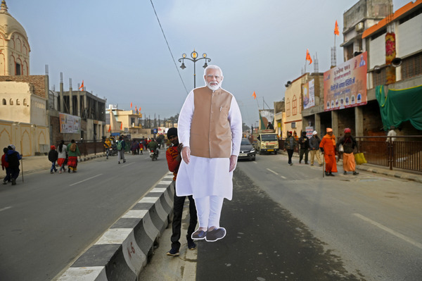 A worker is carrying cutouts of Narendra Modi as part of the preparations for the opening of the Hindu Ram Temple in Ayodhya, Uttar Pradesh, India, on January 18, 2024. © Indranil Aditya/NurPhoto via Getty Images