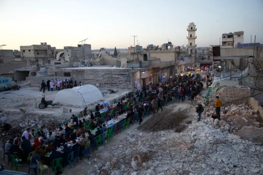 People in the city of Atarab, Syria, break their fast during Ramadan amid the rubble caused by the earthquake in February [Ali Haj Suleiman/Al Jazeera]