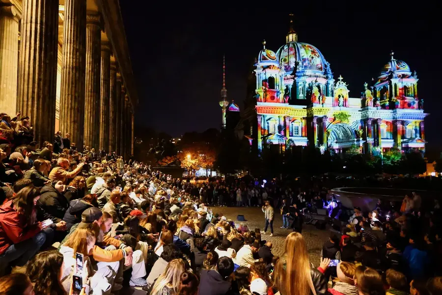 People gather near the illuminated Berlin Cathedral (Berliner Dom) during the Festival of Lights, in Berlin, Germany, October 6. [Fabrizio Bensch/Reuters]
