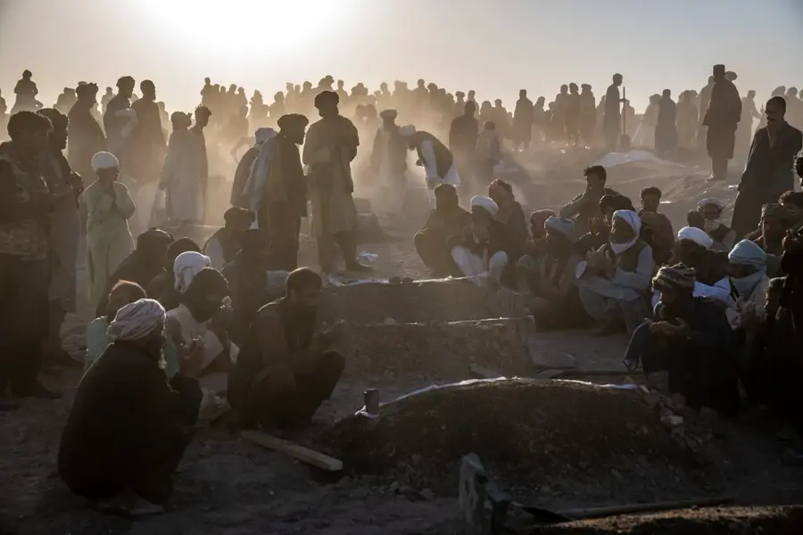 Afghans in Zenda Jan district, Herat province, Afghanistan, bury hundreds of people killed in an earthquake in early October. A series of earthquakes killed and injured thousands and levelled an untold number of homes. [Ebrahim Noroozi/AP Photo]