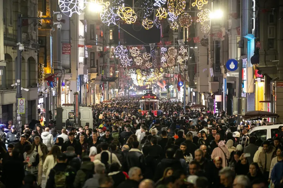 Istiklal Avenue is packed with people ahead of New Year celebrations at Taksim Square in Istanbul, Turkey [Hakan Akgün/Anadolu Agency]