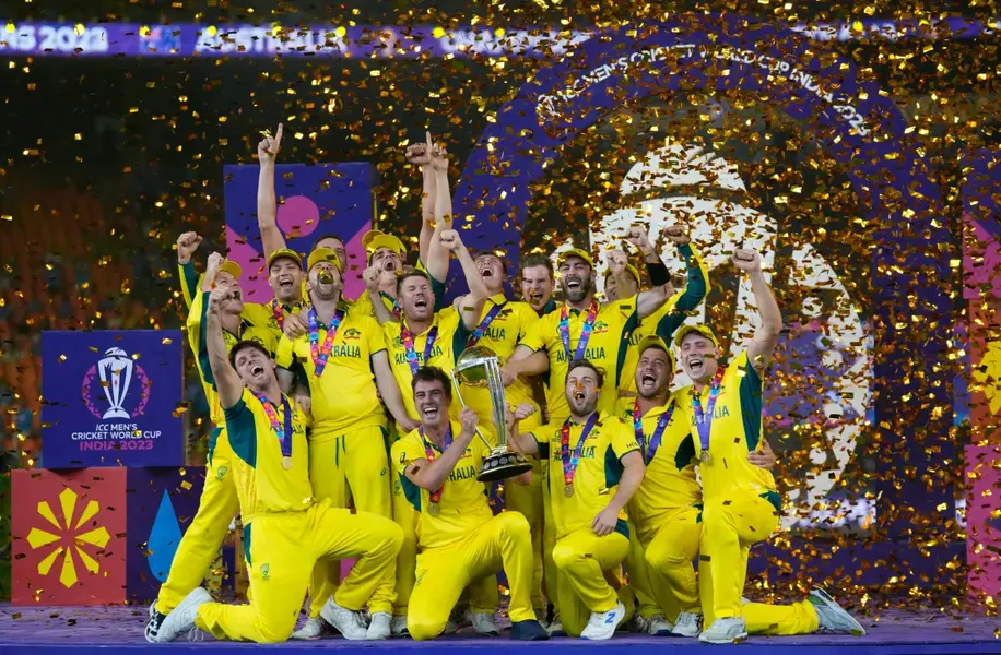 Australian players celebrate with the trophy after beating India during the ICC Men's Cricket World Cup final match in Ahmedabad, India, on November 19. [Aijaz Rahi/AP Photo]