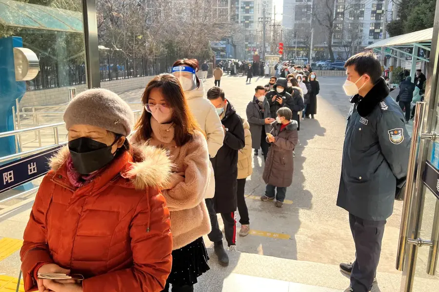 People line up at a government office that issues passports or travel permits to go to Hong Kong, Macau and Taiwan, after China reopened its borders after almost three years, in Beijing, China, on January 9. [Yew Lun Tian/Reuters]