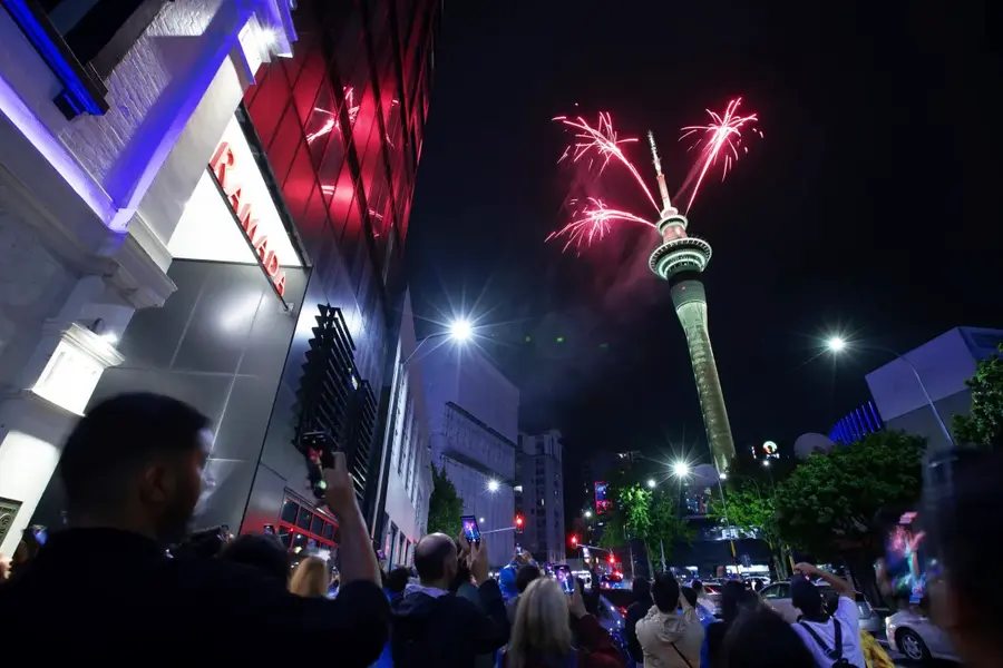 Fireworks burst from the Sky Tower in Auckland, New Zealand, to celebrate the New Year [Hayden Woodward/New Zealand Herald via AP]