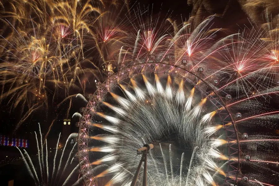 London put on a spectacular 12-minute firework display watched by 100,000 people along the River Thames and many more on television [Hollie Adams/Reuters]