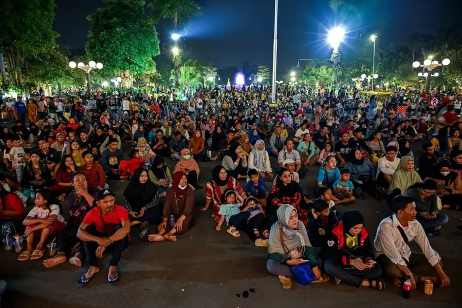 People gather to listen to a music concert to celebrate New Year's Eve at City Hall in Surabaya, Indonesia [Juni Kriswanto/AFP]
