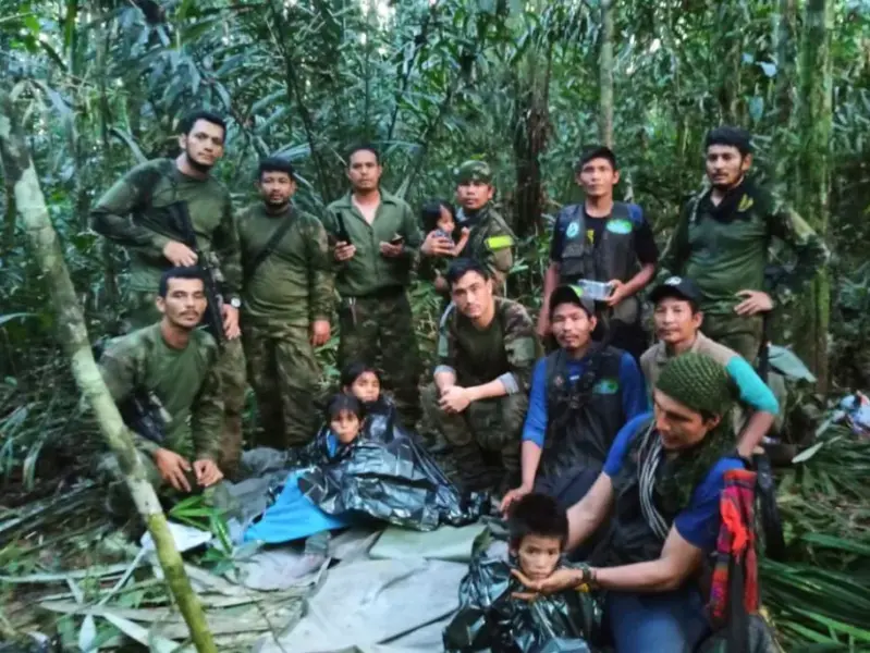 Soldiers and Indigenous men pose with four rescued children, who went missing after surviving a deadly plane crash, in the Solano jungle, Caqueta state, Colombia, June 9. The children survived 40 days in the jungle after the crash that killed their mother. [Colombia's Armed Force Press Office via AP Photo]