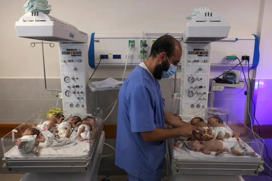 A Palestinian medic cares for premature babies at the Emirates Hospital after they were evacuated from the al-Shifa Hospital - the largest medical facility in Gaza that was attacked by Israel. All 31 premature babies at al-Shifa Hospital were evacuated on November 19 from the facility which the WHO at the time described as a "death zone". Israel has attacked hospitals and medical personnel paralysing the health situation. [Mohammed Abed/AFP]