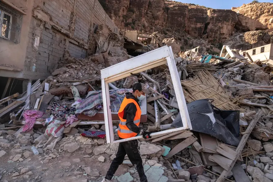 A volunteer helps salvage furniture from homes, damaged by an earthquake, in the town of Imi N'Tala, outside Marrakech, Morocco, on September 13, 2023. [Mosa'ab Elshamy/ AP Photo]